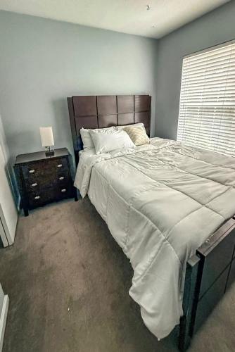 a bedroom with a large bed and a window at Nyakio Suite in Chesapeake