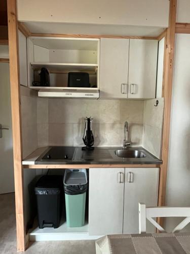 a small kitchen with a sink and a microwave at Chalet 4 personnes in Foix