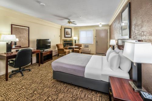 a hotel room with a large bed and a desk at Quality Inn & Suites High Level in High Level