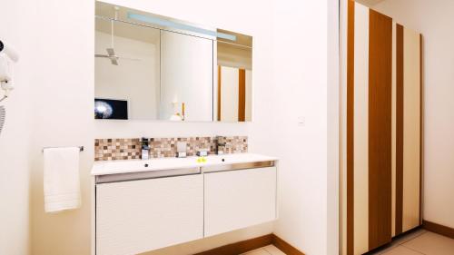 a bathroom with a sink and a mirror at Latitude By Horizon Holidays in Rivière Noire