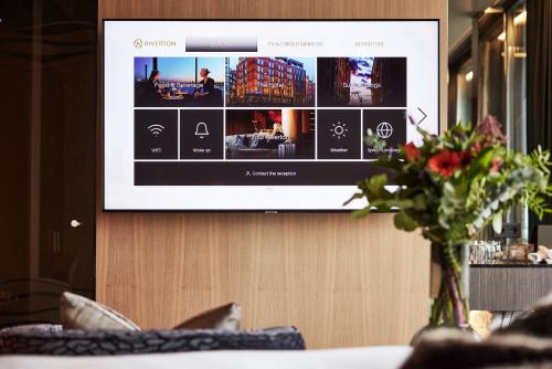 a tv screen with a website on a wall at Hotel Riverton in Gothenburg