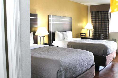 a hotel room with two beds and two lamps at Quality Inn McComb in McComb