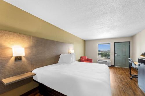 a hotel room with a large bed and a window at Econo Lodge Greenville in Greenville