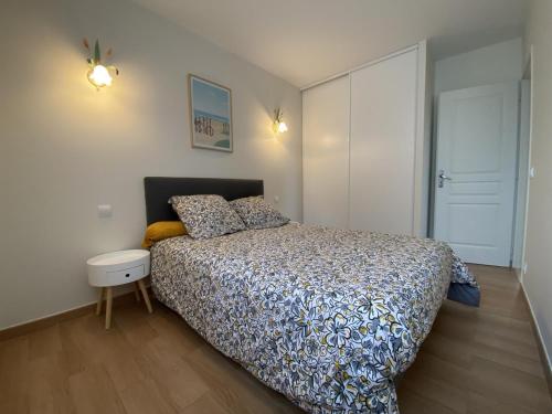 a bedroom with a bed and a white wall at Maliania in Arbonne