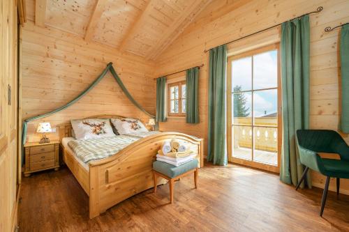 a bedroom with a bed in a wooden house at Chalet Vogelnest am Waldbach in Reit im Winkl