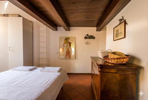 a bedroom with a bed and a wooden dresser at Terrace with a view! in Moltrasio
