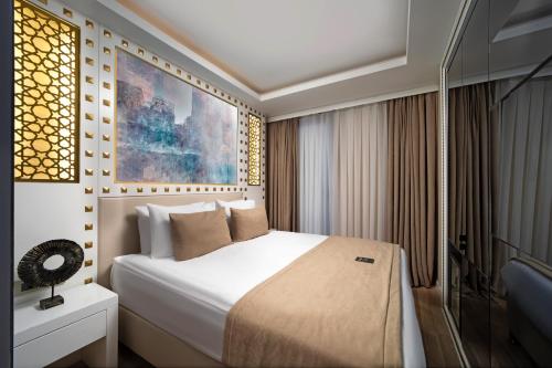 a bedroom with a white bed and a window at Goms Hotel Old City in Istanbul