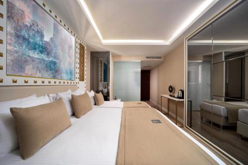 a bedroom with a large white bed in a room at Goms Hotel Old City in Istanbul