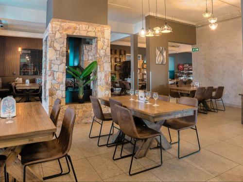 a dining room with wooden tables and chairs at Heidelberg Crown Hotel in Heidelberg
