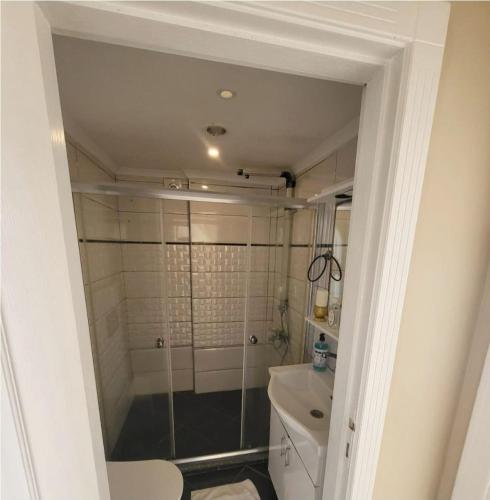 a bathroom with a shower and a toilet at Ng Hisar Apart Hotel in Fethiye