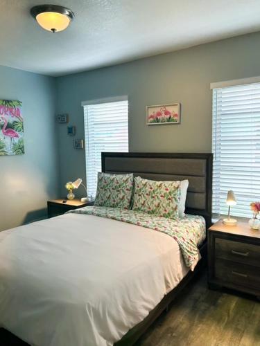 a bedroom with a large bed with two night stands at Coastal Bungalows--The Flamingo Bungalow in Fort Lauderdale