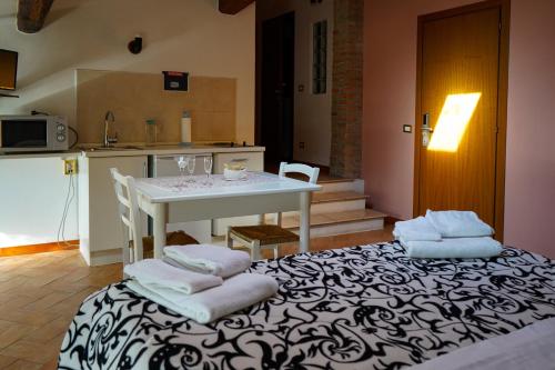 a kitchen with a table and a white table and chairs at Corte Galvana in Cento