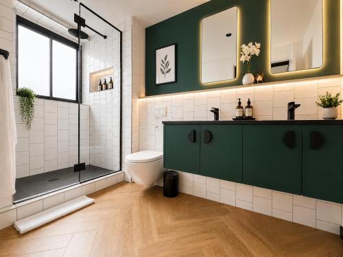 a bathroom with a green cabinet and a shower at ZALS- Nine Palms -Luxury Two Bed in Cape Town