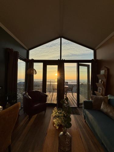 a living room with a large window with a view at Puur Petten in Petten