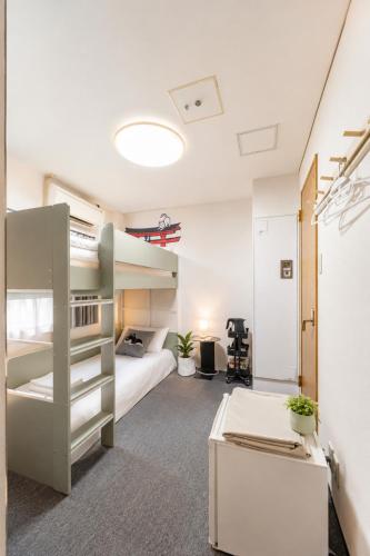 a bedroom with a bunk bed and a desk at Namba 5min by subway OYASUMI Manga HOTEL 24 hours Self-check-in Japanese-Style hotel in Osaka