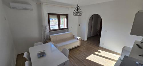 a living room with a couch and a window at Residence Canitano Casa Vacanze Giada & David in Scanzano