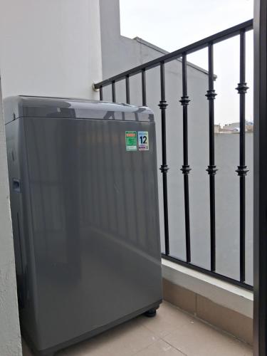 a gray refrigerator sitting next to a railing at Lumina Homes 2 Lai Xá in Thuong Thon