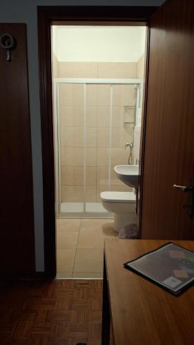 a bathroom with a shower and a toilet and a sink at Locanda El Piron in Chiampo
