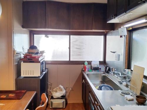 a small kitchen with a sink and a window at 和庵-Nagomian- in Kasaoka