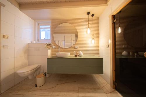 a bathroom with a sink and a mirror at SATAMA Sauna Resort & SPA in Wendisch Rietz