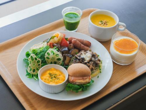 a tray with a plate of food on a table at Hotel Anteroom Kyoto in Kyoto