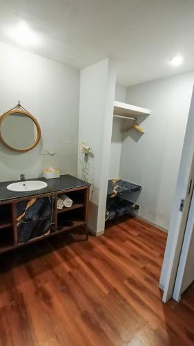 a bathroom with a sink and a mirror at Dealton Hotel Sanur in Sanur