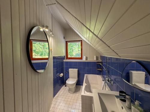 a bathroom with a sink and a toilet and a mirror at Willa Hacienda in Międzybrodzie Żywieckie