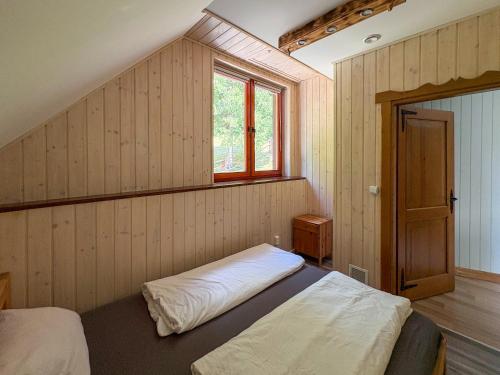 a bedroom with a bed and a window at Willa Hacienda in Międzybrodzie Żywieckie