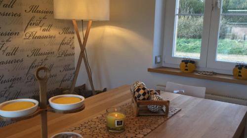 a dining room table with two bowls on top of it at Le Pot de Miel d'Ugny in Ugny