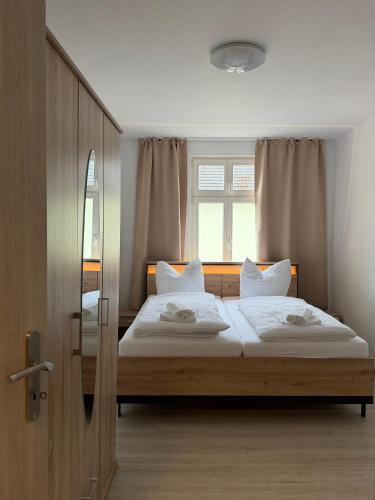 a bedroom with two beds and a window at FeWo Augusta in Neustrelitz