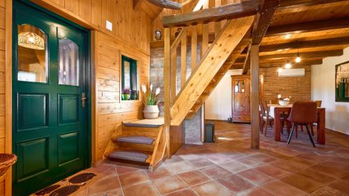 a wooden hallway with a green door and a table at Villa Velika by Villas Guide in Pisarovina