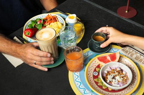two people sitting at a table with plates of food at 66 Guldsmeden in Copenhagen