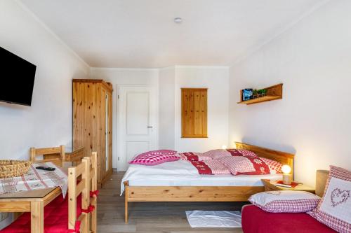 a bedroom with a bed and a table at Auszeit am Fluss - Donau in Obernzell