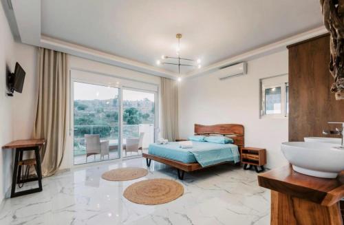 a bathroom with a bed and a sink and a tub at Lindos Villa Aqua Euphoria ex Natura in Lindos