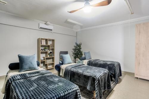 a room with two beds and a ceiling fan at Heidelberg Crown Hotel in Heidelberg