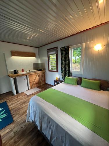 a bedroom with a large bed with green pillows at Kai Kabana Chill in HUH