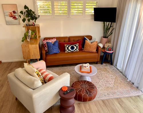 a living room with a couch and a table at Lil Sass in Mudjimba