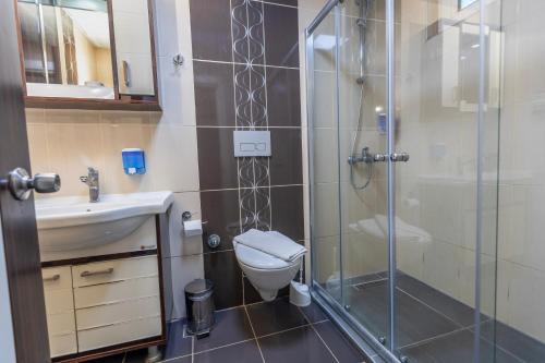 a bathroom with a shower and a toilet and a sink at Citrus Urban Hotel in Antalya