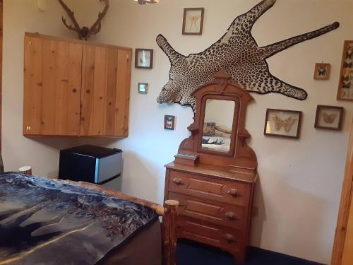 a bedroom with a dresser and a star fish on the wall at Hungry Moose B and B in Kasilof