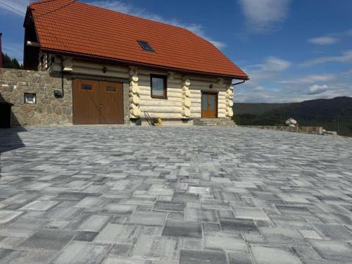 a house with a brick driveway in front of a building at Садиба Сикитура in Verkhneye Vodyanoye