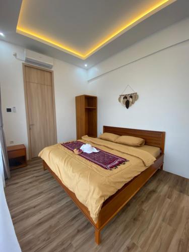 a bedroom with a large bed in a room at Svaha Ubud Villas in Siantan