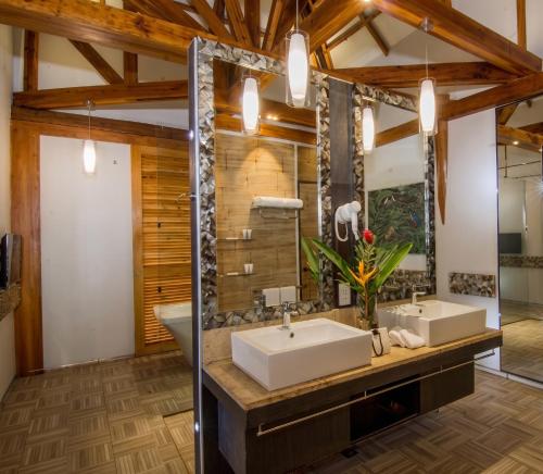 a bathroom with two sinks and a shower at Donatela Resort and Sanctuary in Panglao Island