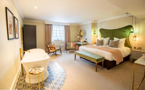 a hotel room with a bed and a bathroom at The Gonville Hotel, a member of Radisson Individuals in Cambridge