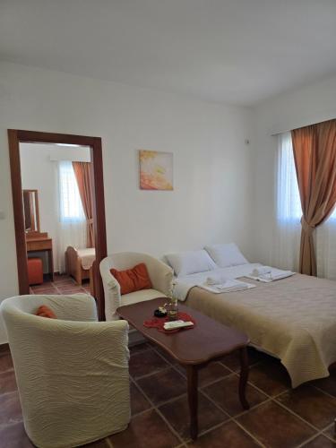 a bedroom with a bed and a table and chairs at Villa Ipera in Budva
