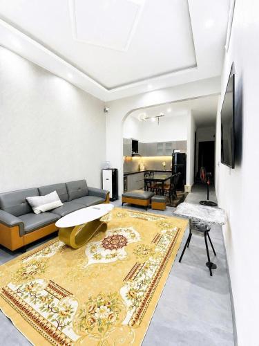 a living room with a couch and a rug at Mubee Homestay in Hue