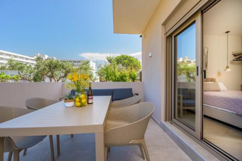 a white table and chairs on a balcony at MSBeach Luxury Homes - Manolis in Kos