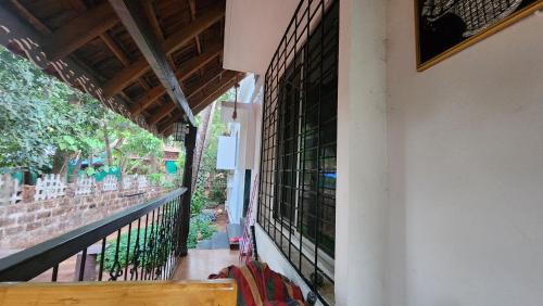 a balcony of a house with green glass windows at Bhatye Beach Resort MTDC in Ratnagiri