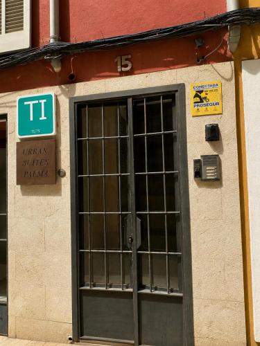 a door to a building with a sign on it at Urban Suites Palma - Turismo de Interior by PriorityVillas in Palma de Mallorca