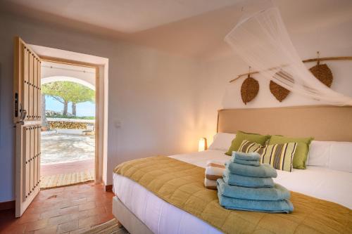 a bedroom with a bed with towels on it at Mongofre Agroturismo in Mahón