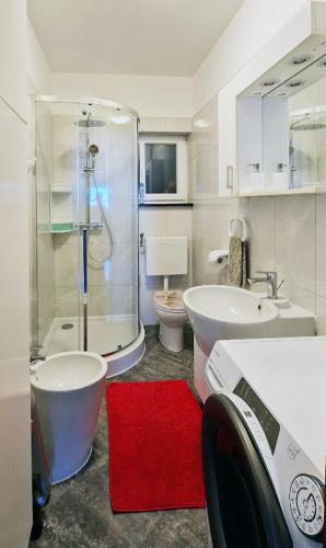 a bathroom with a shower and a toilet and a sink at Lukovo Seafront Apartments in Lukovo